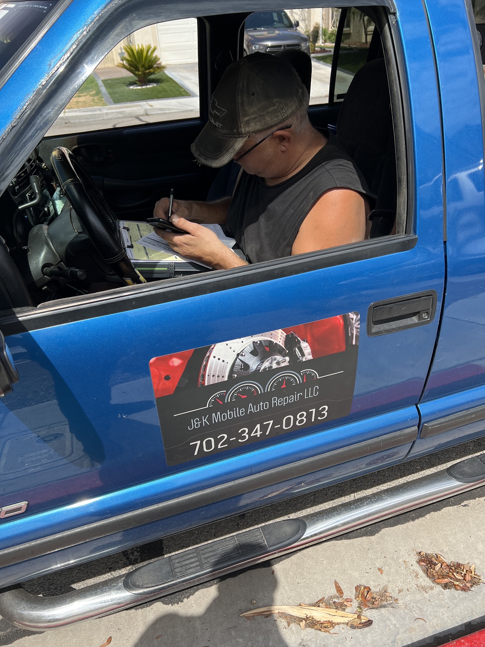 Blue service truck with J&K Mobile Auto Repair LLC door magnet and phone number